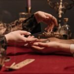 A fortune teller delicately reading a client's palm in a mystic setting with enchanting ambiance.